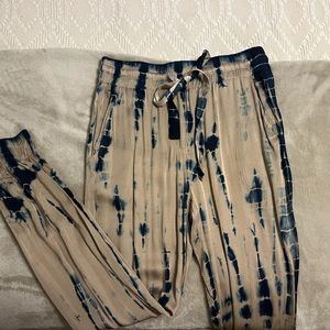 Olivaceous tye dye satin joggers